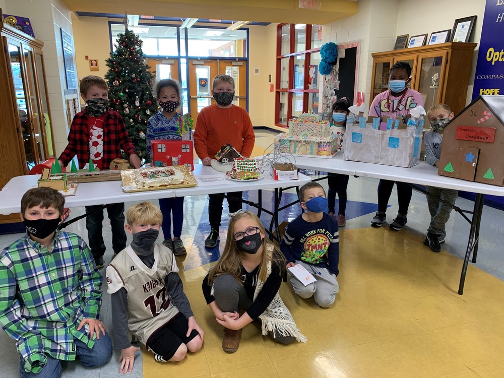 Students posing with gingerbread structures